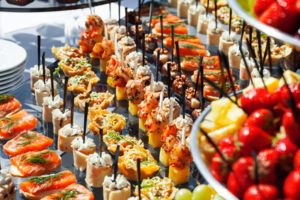 meat, fish, vegetable canapés on a festive wedding table outdoor